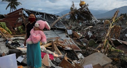 A woman holds a stuffed rabbit toy after it was found at her destroyed home where she said she had lost her three children, in Palu, Central Sulawesi, Indonesia, October 7, 2018. REUTERS/Jorge Silva